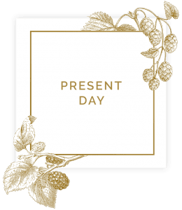 Sign saying present day in square with floral decorations